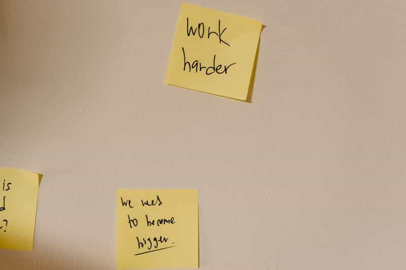 Sticky notes grouped into columns on a wall while planning a piece of writing